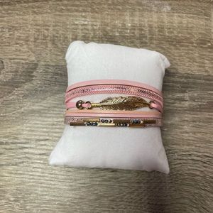 Pink feather detailed bracelet stack with clasp to close
